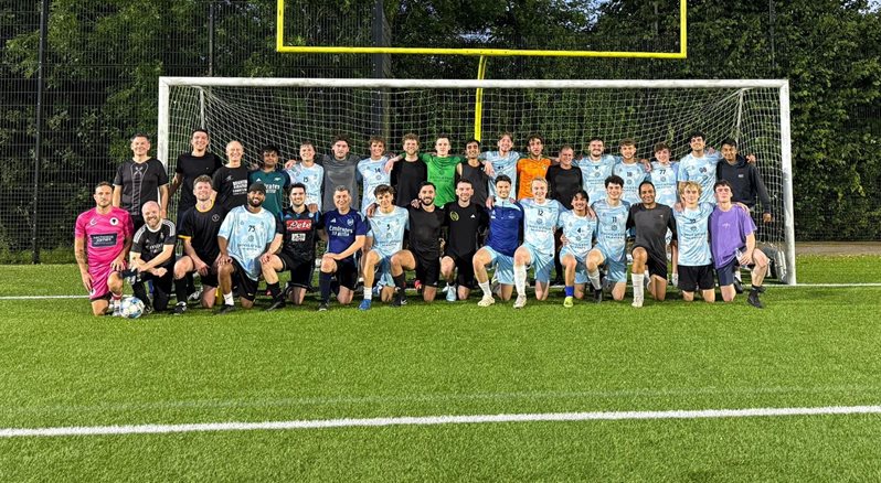 Group photo of BSMS men's football team in front of the goal post