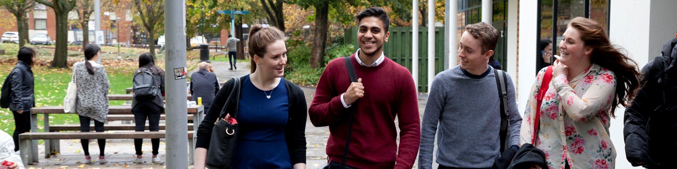 Four students walk through campus